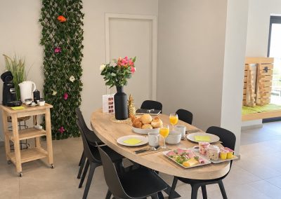 Gedekte ontbijttafel met bloemen in de wellnessruimte van Total Care